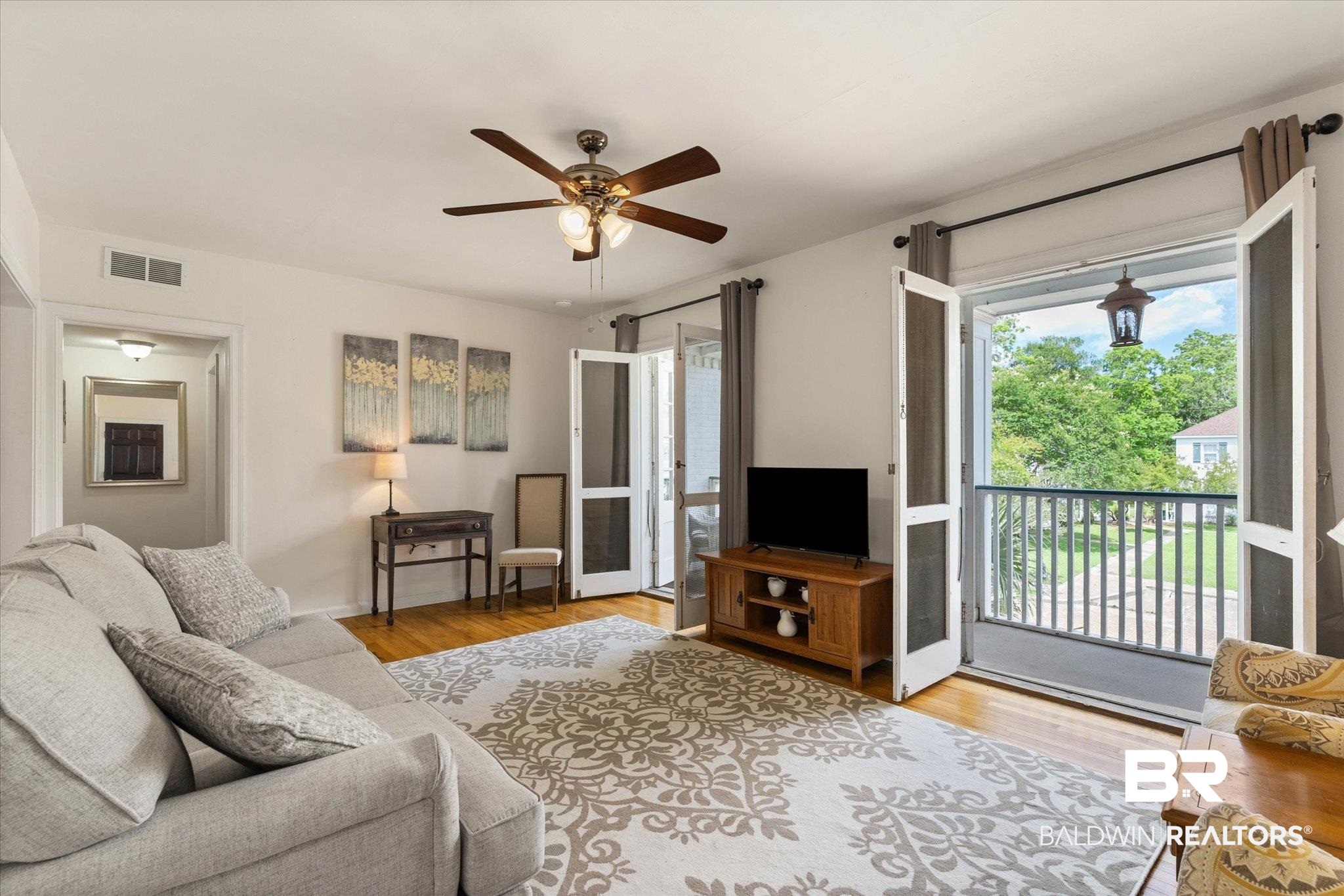 214 Upham Street, Unit 18C Mobile, AL 36607 - Photo 4 of 35 Living room with a ceiling fan and wood finished floors