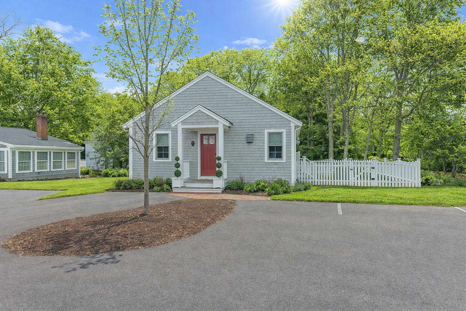 a view of a house with a backyard and a tree