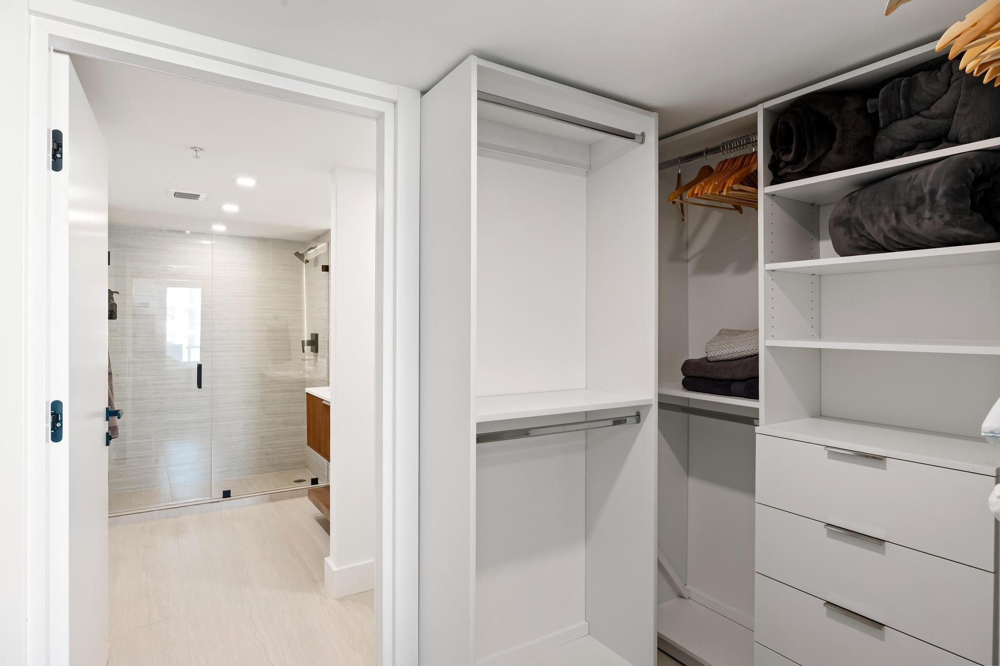 9499 Collins Avenue, Unit 603 Surfside, FL 33154 - Photo 17 of 42 Primary closet overlooking the bathroom