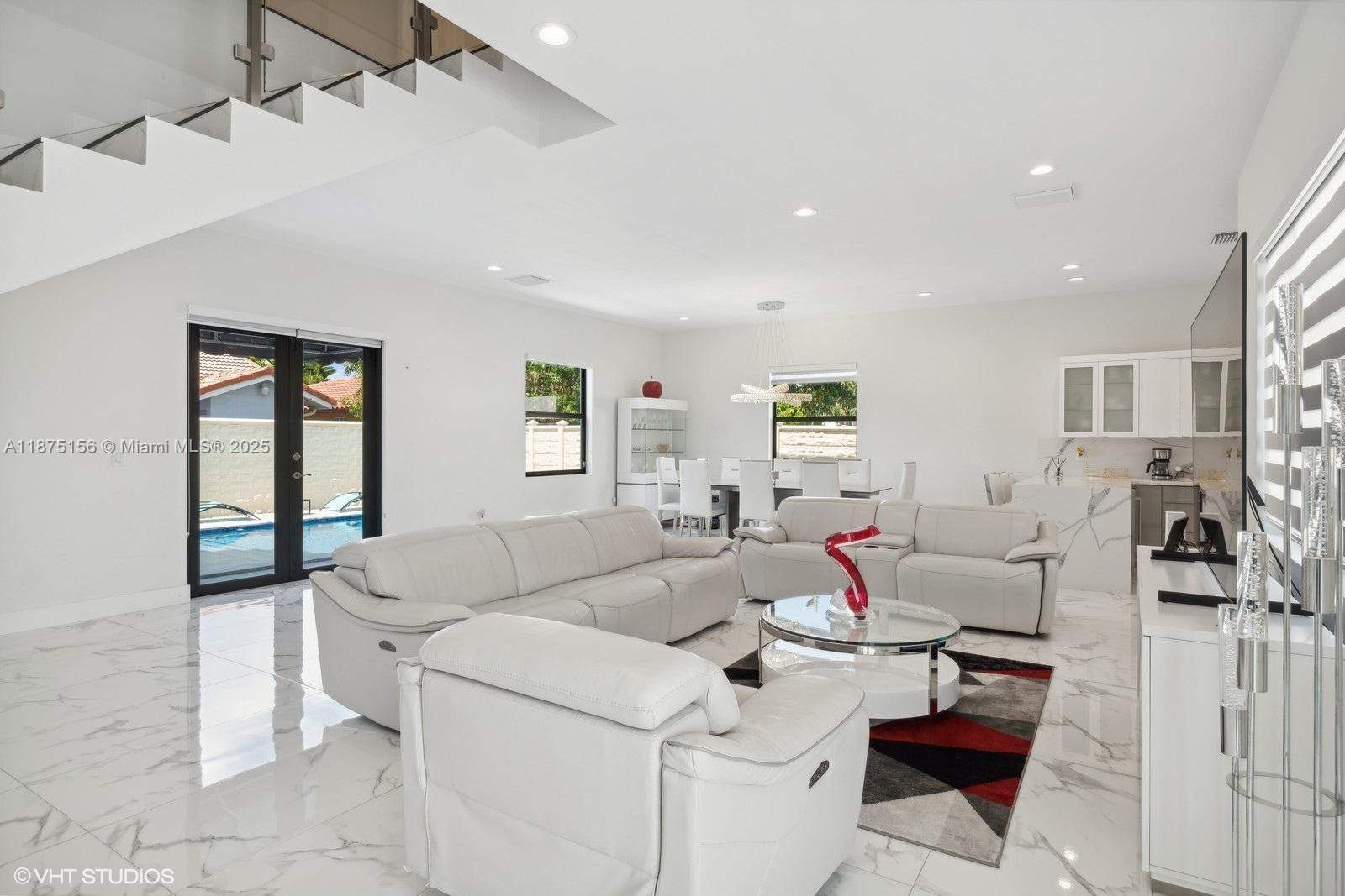 13331 Southwest 41st Street Miami, FL 33175 - Photo 2 of 8 a living room with furniture and a large window