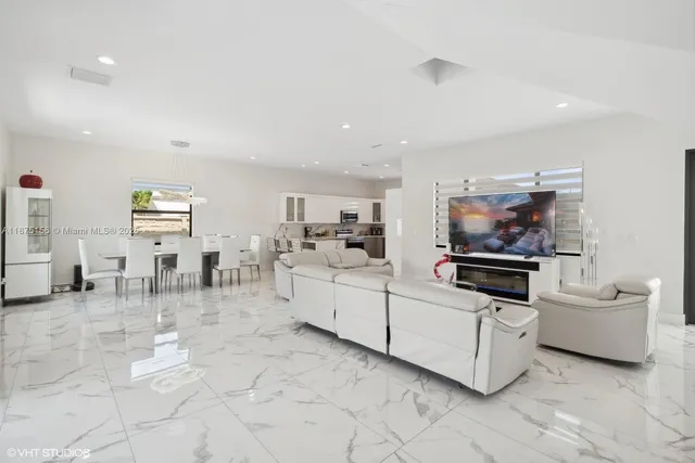 a living room with furniture and white furniture