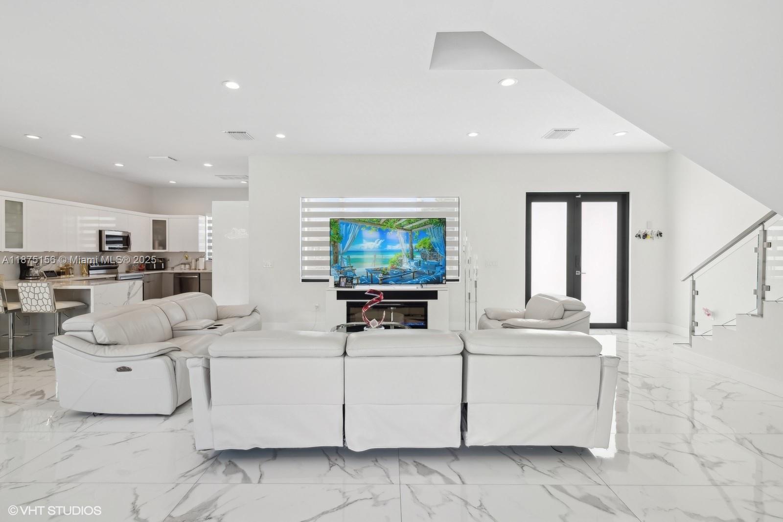 13331 Southwest 41st Street Miami, FL 33175 - Photo 4 of 8 a living room with furniture a flat screen tv and white floor