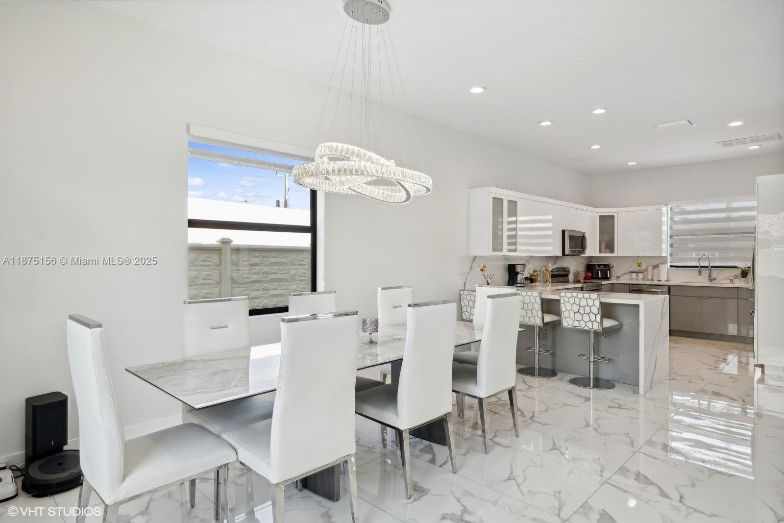 13331 Southwest 41st Street Miami, FL 33175 - Photo 5 of 8 a kitchen with a dining table chairs and view living room
