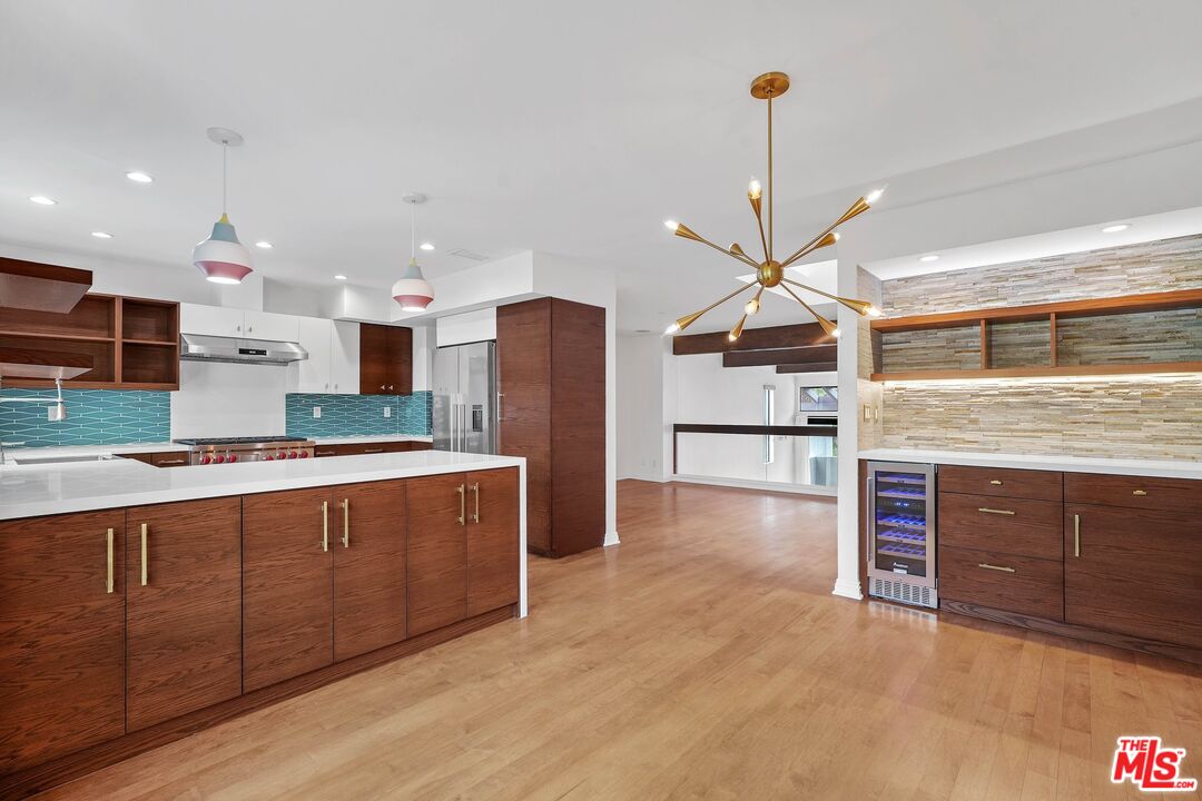 1569 Michael Lane Pacific Palisades, CA 90272 - Photo 13 of 31 a large kitchen with stainless steel appliances granite countertop a refrigerator and a stove top oven