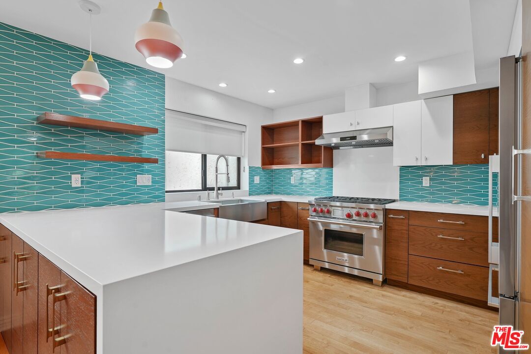 1569 Michael Lane Pacific Palisades, CA 90272 - Photo 18 of 31 a kitchen with stainless steel appliances granite countertop a sink and a stove