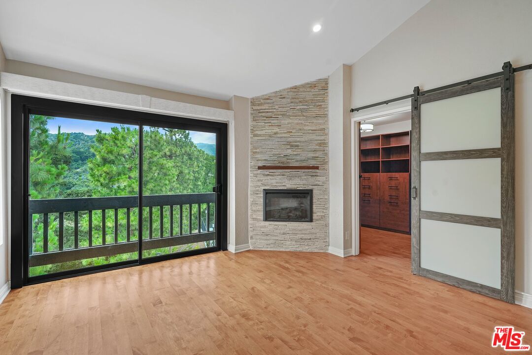 1569 Michael Lane Pacific Palisades, CA 90272 - Photo 23 of 31 a view of empty room with a fireplace and floor to ceiling window
