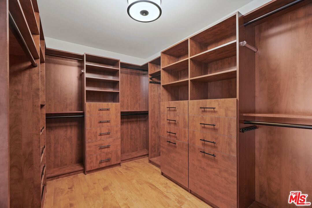 1569 Michael Lane Pacific Palisades, CA 90272 - Photo 24 of 31 a view of walk in closet with clothes and shoes