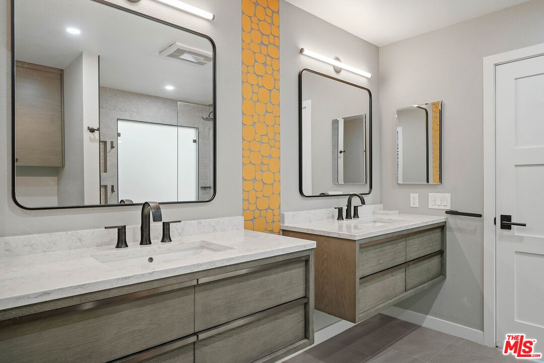 1569 Michael Lane Pacific Palisades, CA 90272 - Photo 26 of 31 a bathroom with double vanity sinks and a mirror