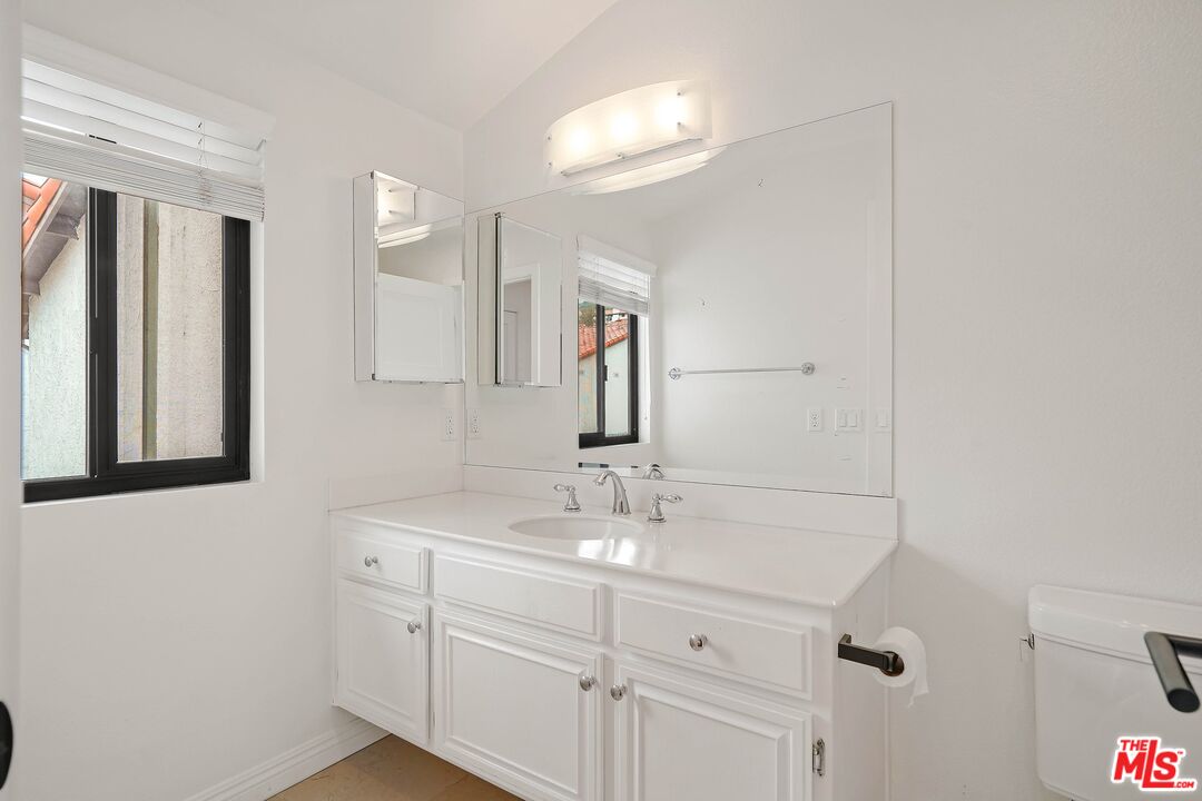 1569 Michael Lane Pacific Palisades, CA 90272 - Photo 29 of 31 a bathroom with a sink and a mirror