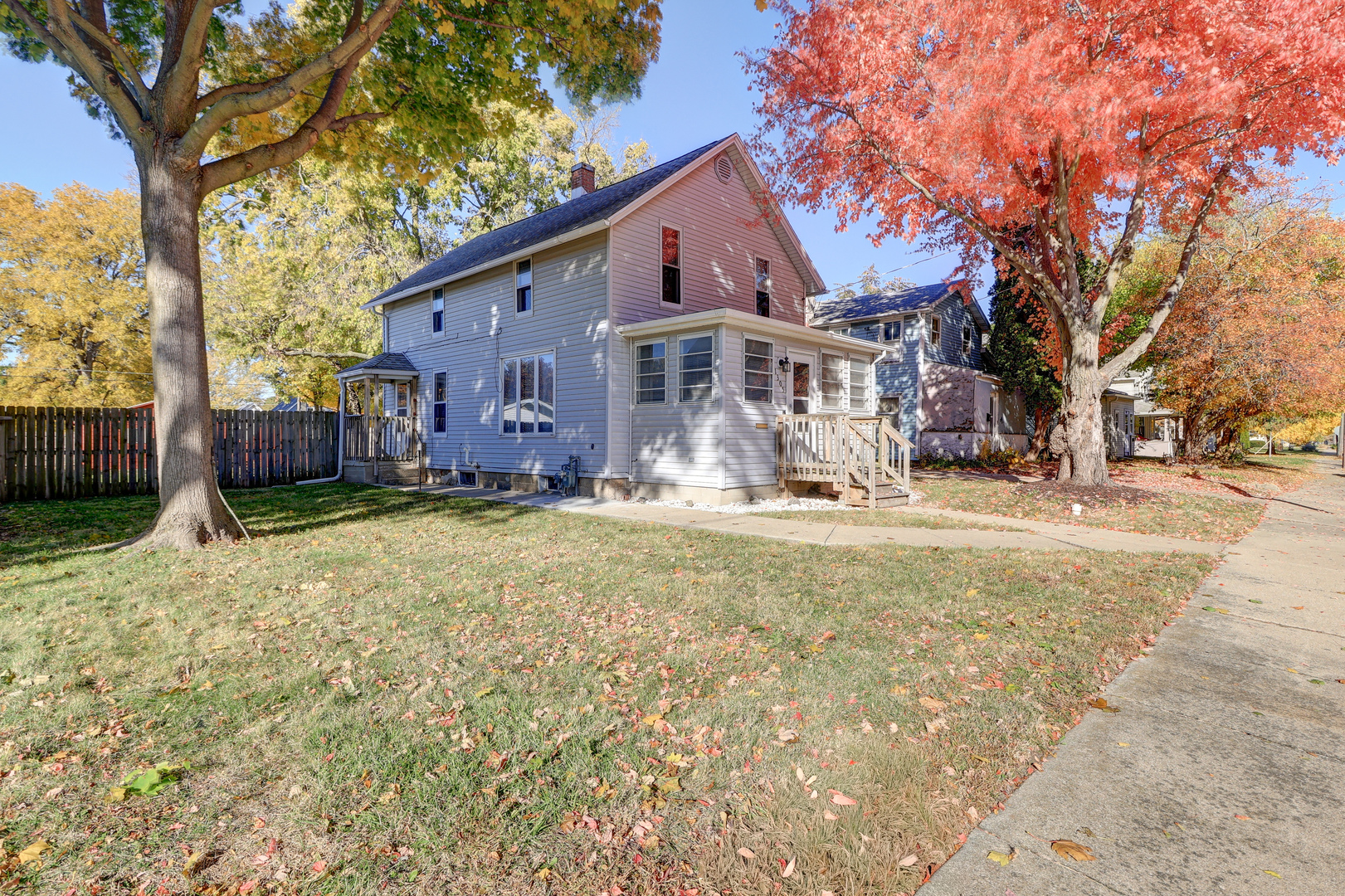 a view of a house with a yard covered with snow