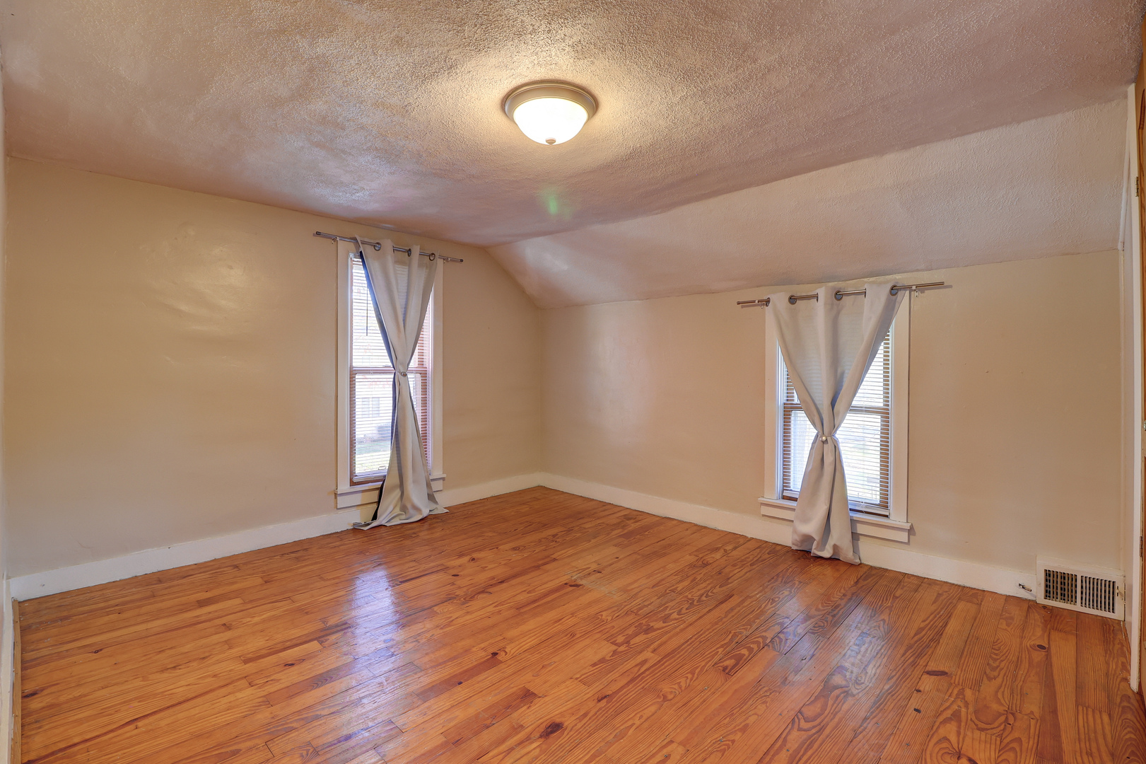 1305 3rd Avenue Sterling, IL 61081 - Photo 14 of 29 an empty room with wooden floor and windows