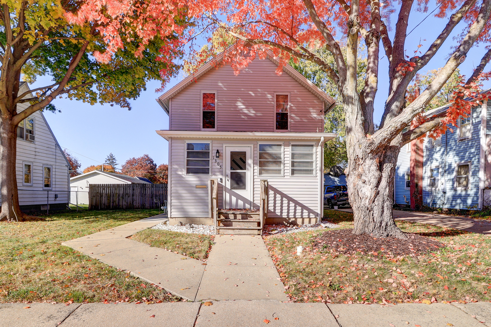 1305 3rd Avenue Sterling, IL 61081 - Photo 27 of 29 a front view of a house with a yard covered with cars and trees