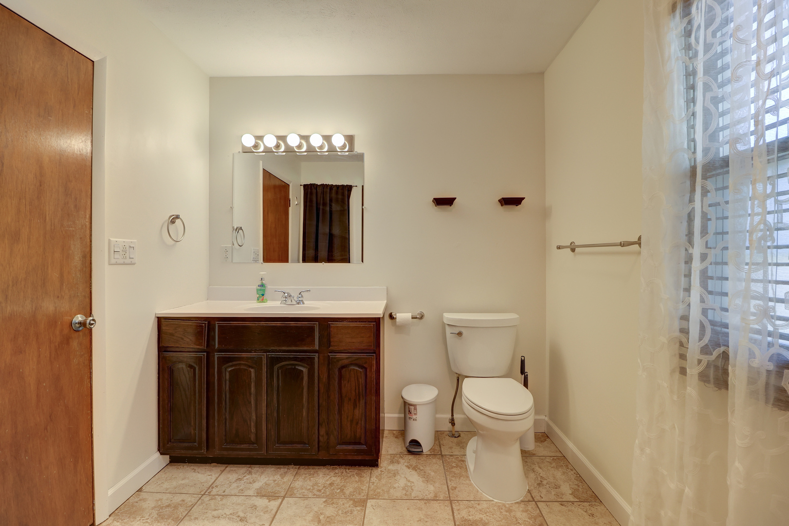 1305 3rd Avenue Sterling, IL 61081 - Photo 10 of 29 a bathroom with a toilet sink and mirror