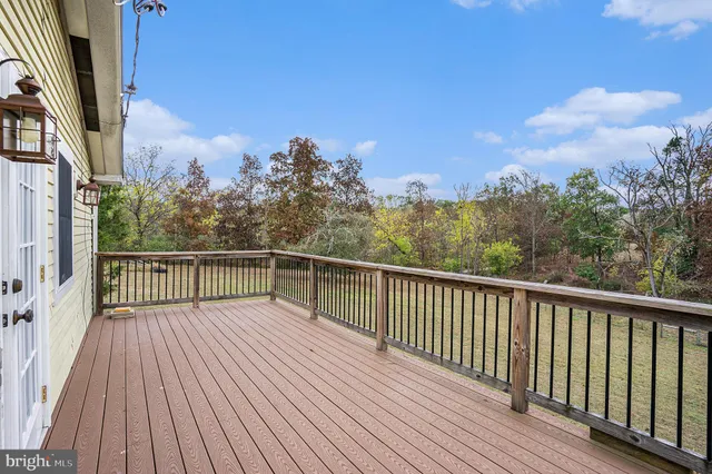 a view of balcony with wooden floor and fence
