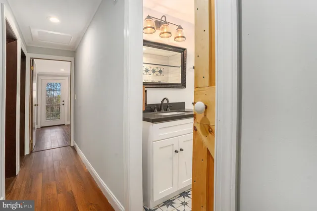 a hallway with sliding door and wooden floor