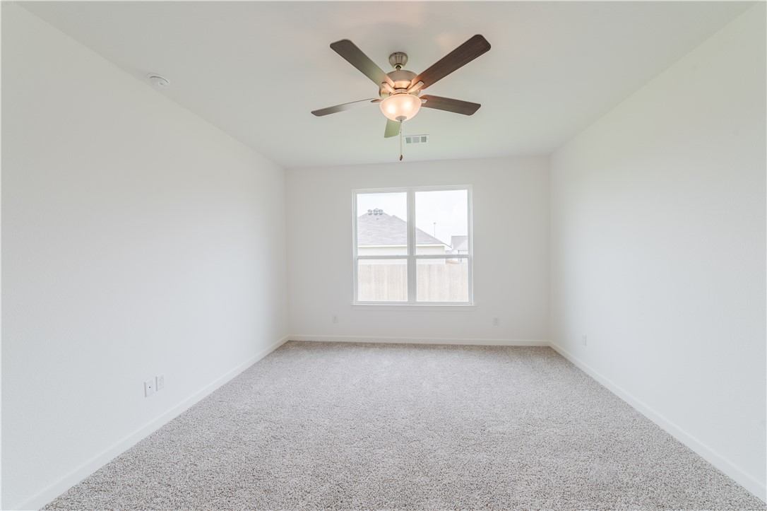 1901 Sebright Drive Bryan, TX 77807 - Photo 8 of 13 an empty room with a window and a ceiling fan