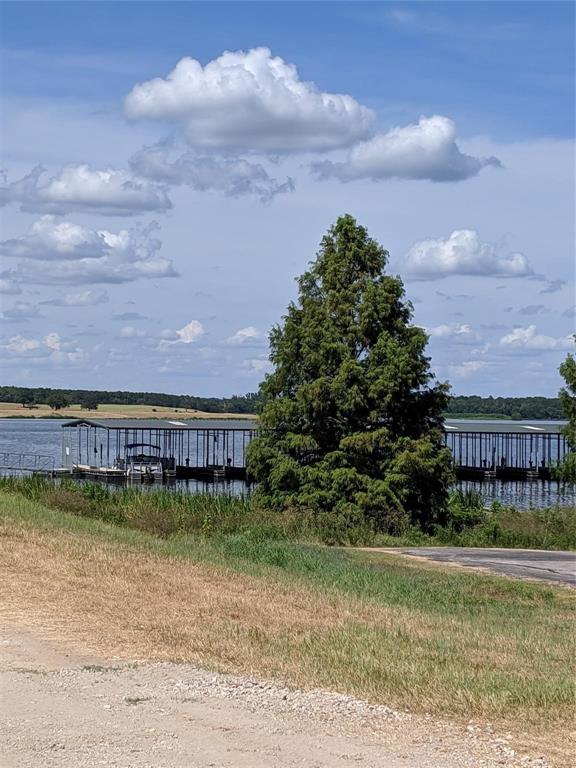 7710 Shore Crest Way Athens, TX 75752 - Photo 15 of 17 a view of a swimming pool with lawn chairs and iron fence