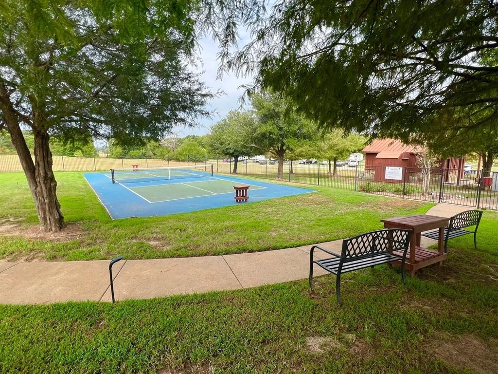 7710 Shore Crest Way Athens, TX 75752 - Photo 17 of 17 a view of a swimming pool with a bench and trees around