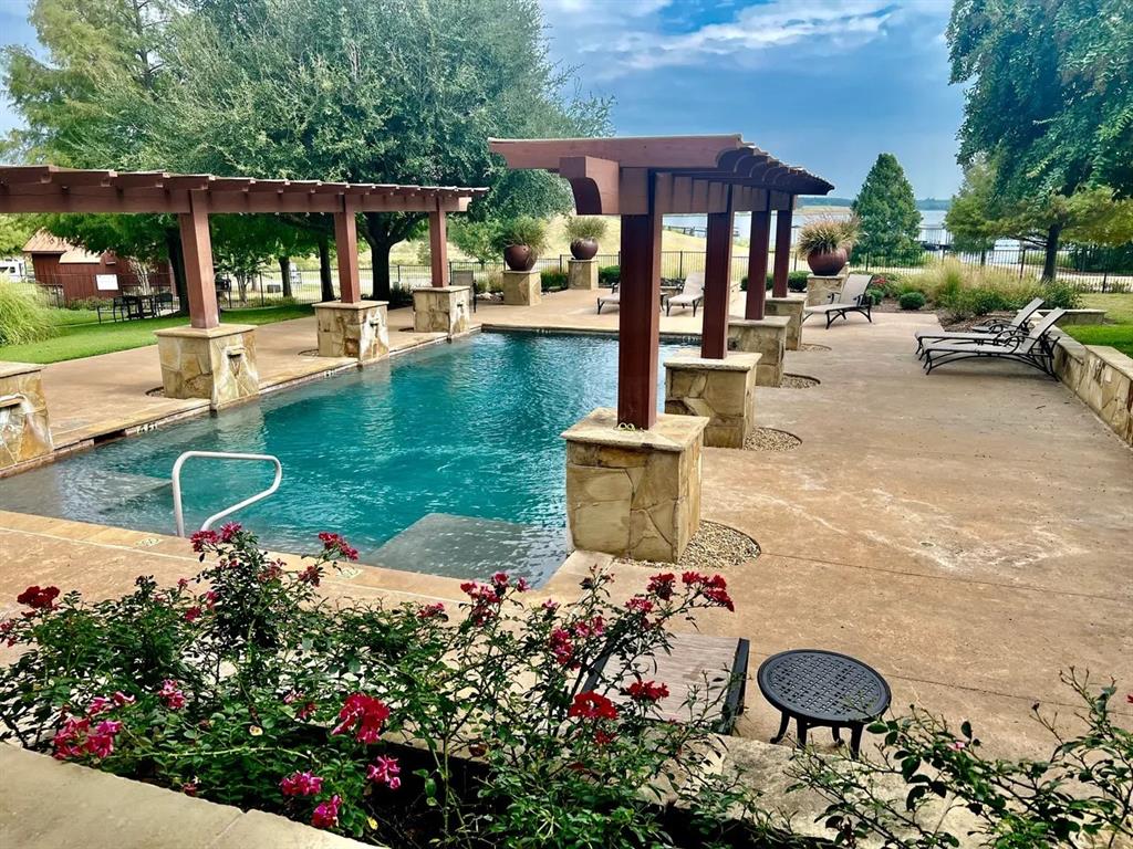 7710 Shore Crest Way Athens, TX 75752 - Photo 10 of 17 a front view of a house with swimming pool garden and patio
