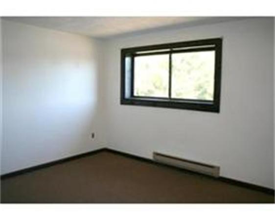318 Codman Hill Road, Unit 34E Boxborough, MA 01719 - Photo 11 of 14 a view of an empty room and window