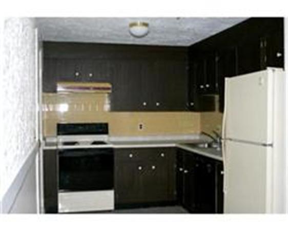 318 Codman Hill Road, Unit 34E Boxborough, MA 01719 - Photo 5 of 14 a kitchen with a sink and a refrigerator