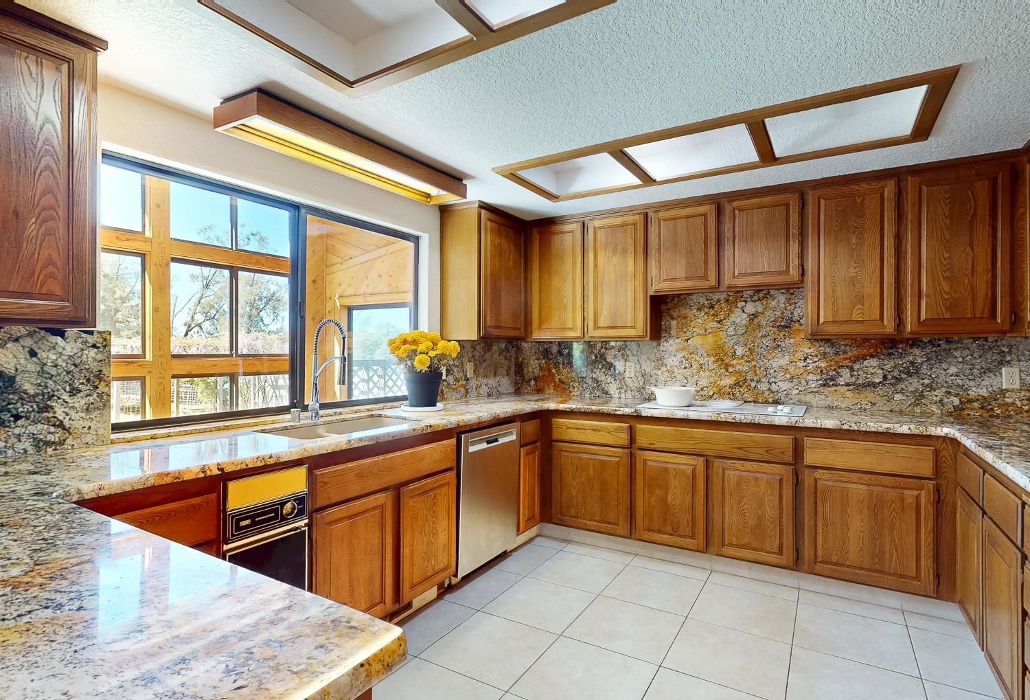 22801 Hidden Ranch Road Auburn, CA 95602 - Photo 20 of 94 a kitchen with a sink stove and cabinets