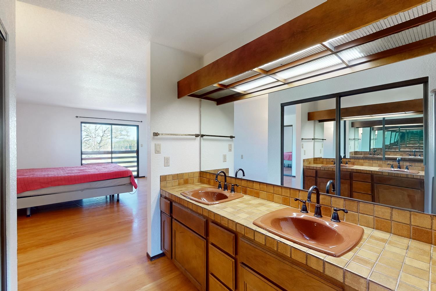 22801 Hidden Ranch Road Auburn, CA 95602 - Photo 24 of 94 a bathroom with a sink and a large mirror