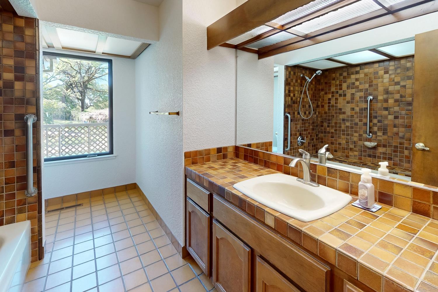 22801 Hidden Ranch Road Auburn, CA 95602 - Photo 34 of 94 a bathroom with a sink and a mirror