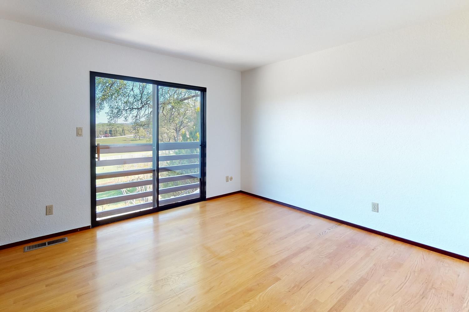 22801 Hidden Ranch Road Auburn, CA 95602 - Photo 38 of 94 an empty room with wooden floor and windows