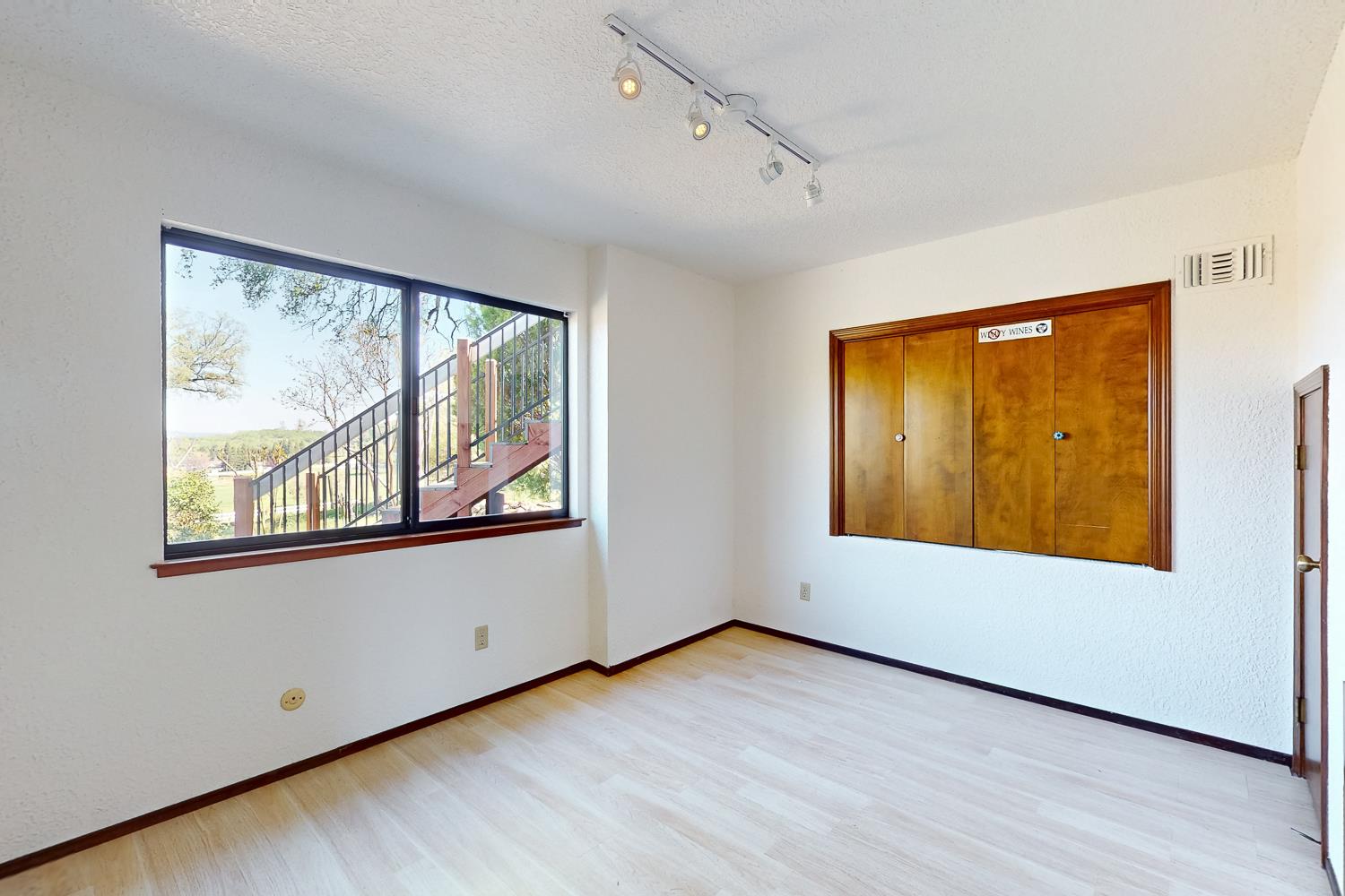 22801 Hidden Ranch Road Auburn, CA 95602 - Photo 49 of 94 an empty room with wooden floor and windows
