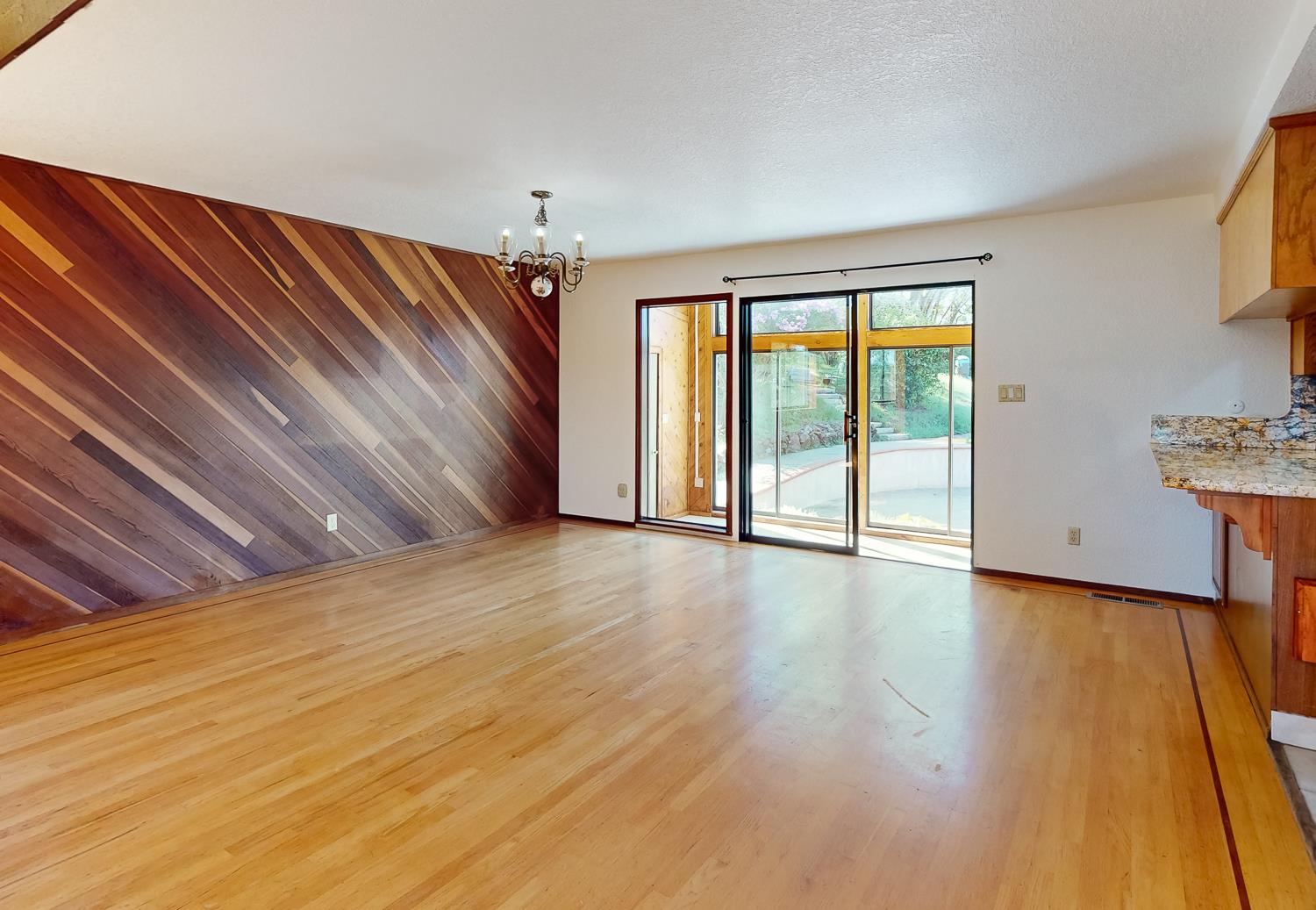 22801 Hidden Ranch Road Auburn, CA 95602 - Photo 5 of 94 a view of an empty room with wooden floor and a window