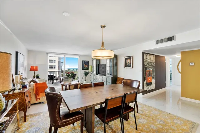 a dining room with furniture window and wooden floor