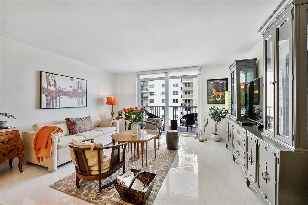 1601 South Ocean Drive, Unit 902 Hollywood, FL 33019 - Photo 15 of 40 a living room with furniture a couch and a bookshelf next to a window