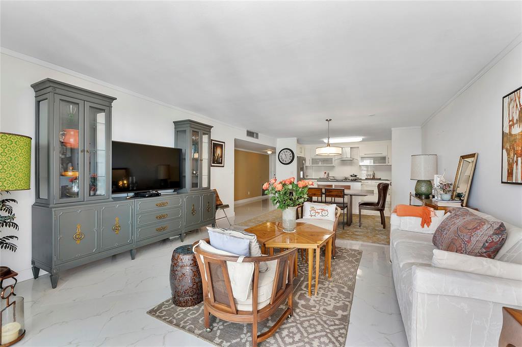 1601 South Ocean Drive, Unit 902 Hollywood, FL 33019 - Photo 16 of 40 a living room with furniture a flat screen tv and kitchen view