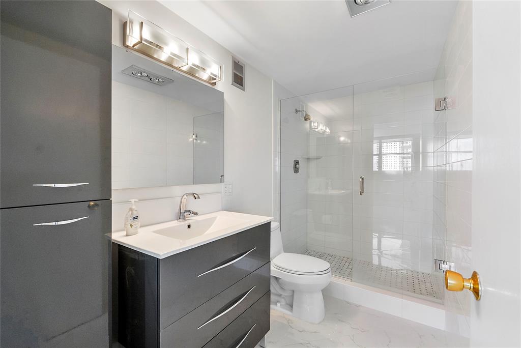 1601 South Ocean Drive, Unit 902 Hollywood, FL 33019 - Photo 21 of 40 a bathroom with a sink a toilet and shower