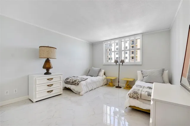 a bedroom with two beds and a window