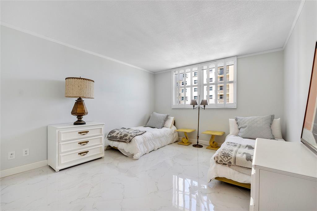 1601 South Ocean Drive, Unit 902 Hollywood, FL 33019 - Photo 24 of 40 a bedroom with two beds and a window