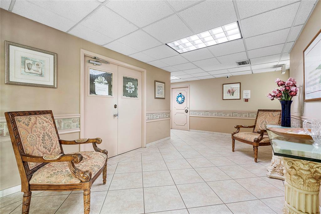 1601 South Ocean Drive, Unit 902 Hollywood, FL 33019 - Photo 36 of 40 a spacious bedroom with a bed a desk and chair