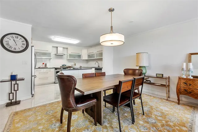 a dining room with furniture and a chandelier