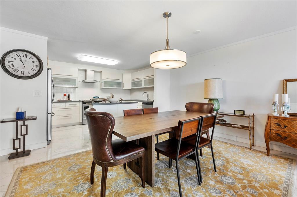 1601 South Ocean Drive, Unit 902 Hollywood, FL 33019 - Photo 5 of 40 a dining room with furniture and a chandelier
