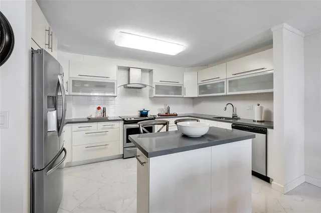 a kitchen with a sink stove and refrigerator