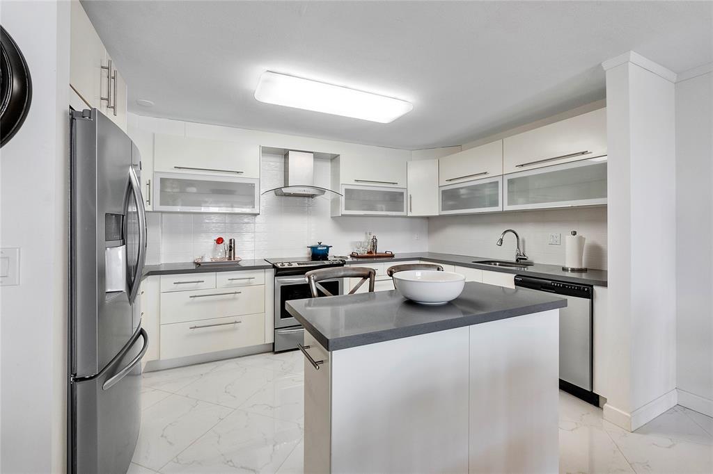 1601 South Ocean Drive, Unit 902 Hollywood, FL 33019 - Photo 6 of 40 a kitchen with a sink stove and refrigerator