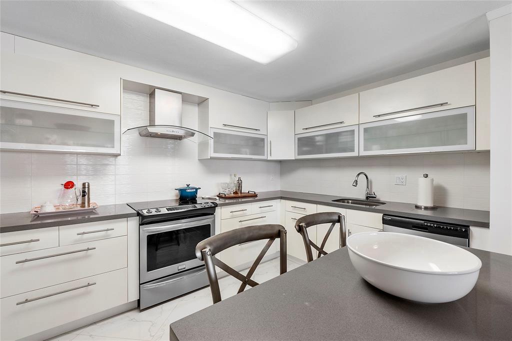 1601 South Ocean Drive, Unit 902 Hollywood, FL 33019 - Photo 7 of 40 a kitchen with stainless steel appliances a white wooden cabinets and stove