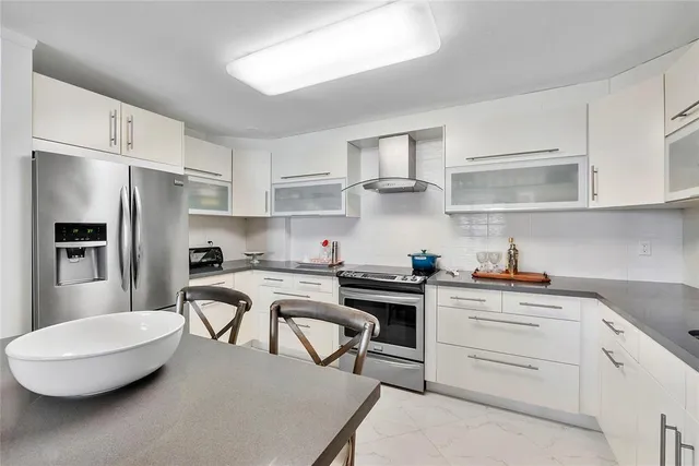 a kitchen with white cabinets stainless steel appliances and a sink