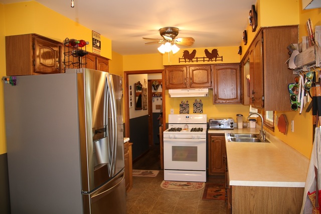 14483 Perry Road DeKalb, IL 60115 - Photo 4 of 14 a kitchen with stainless steel appliances granite countertop a refrigerator and a stove