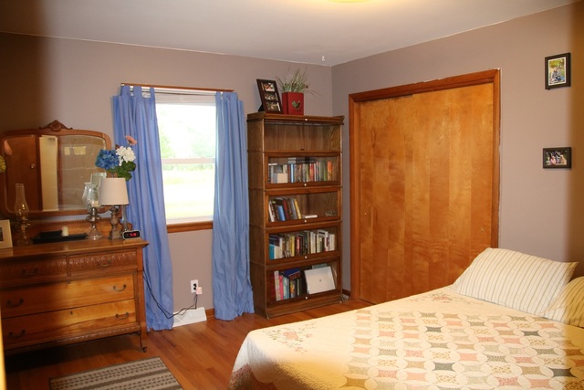 14483 Perry Road DeKalb, IL 60115 - Photo 8 of 14 a bedroom with a bed and a dresser