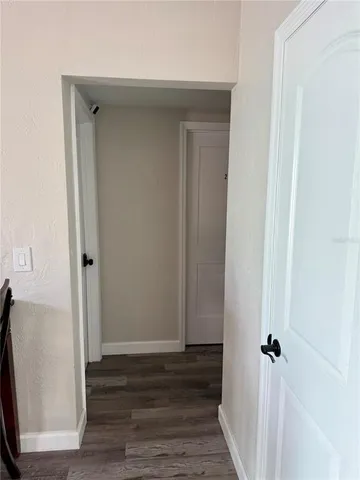 a view of a hallway with wooden floor