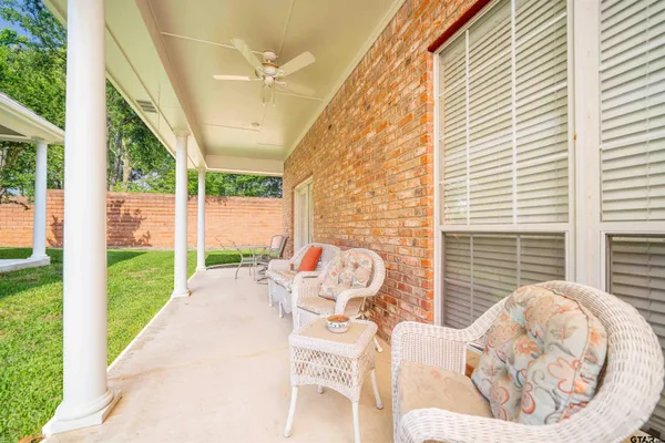 a view of a patio with chairs and a yard