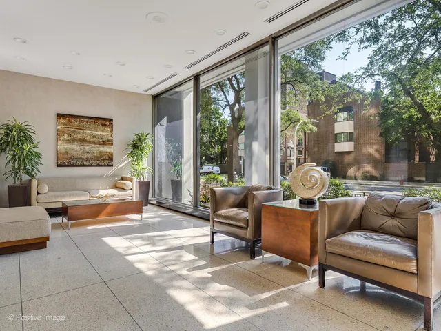 a living room with patio furniture and a large window