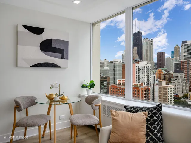 a living room with furniture and a floor to ceiling window